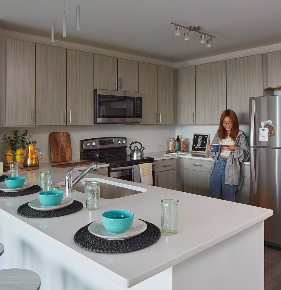 A woman standing in a kitchen